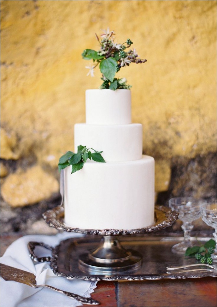 white wedding cake with green leaves